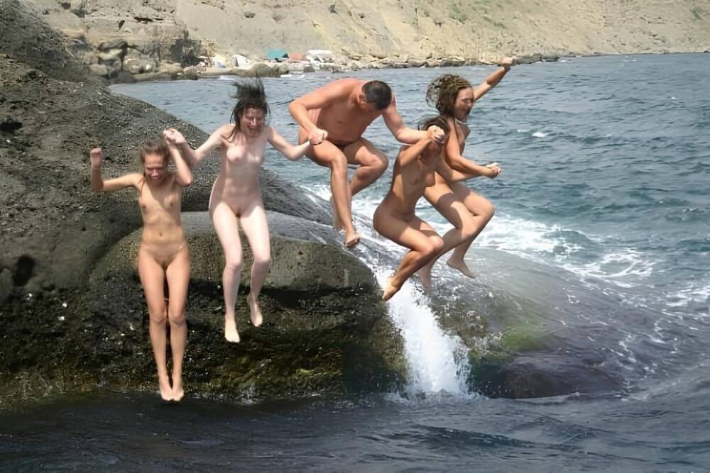 Mens and girls nudists on a beach - Peace and tranquility are important values for naturists