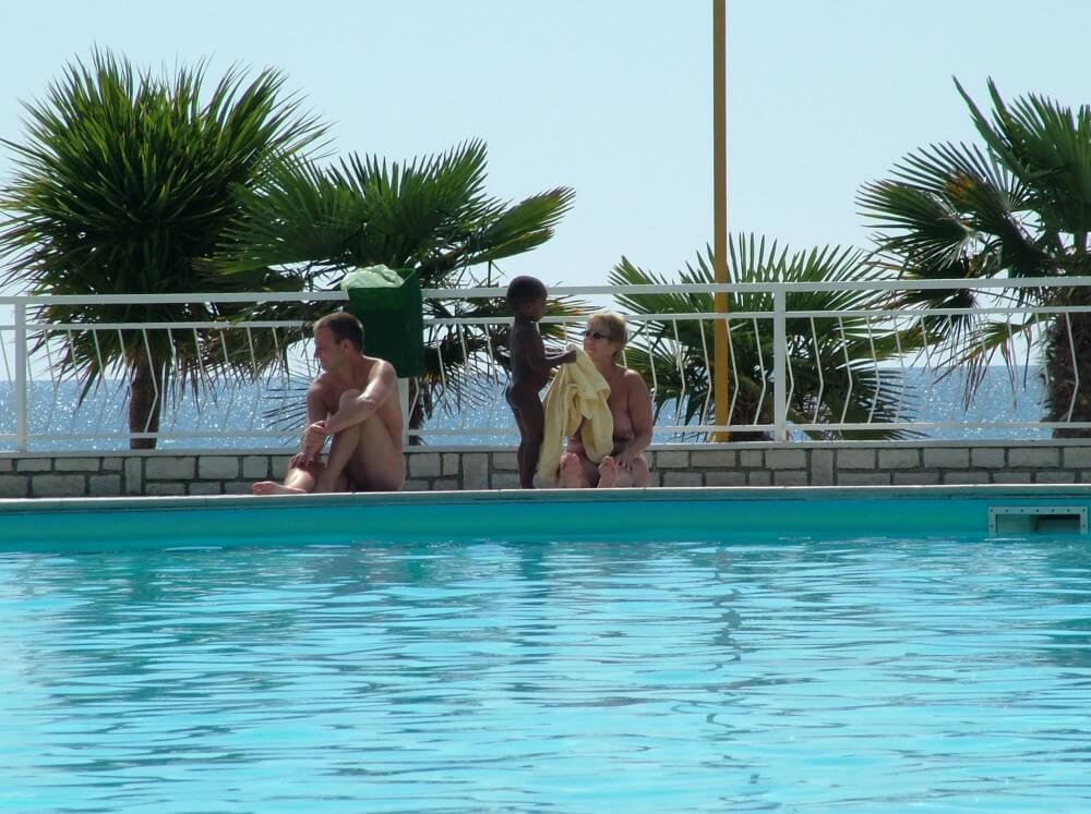 Photo of naturists in an outdoor pool - The Theory and Practice of Naturism